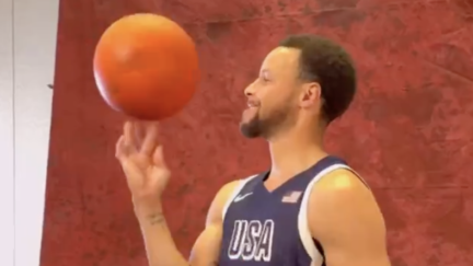 Steph Curry spins a basketball on his finger